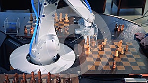 Close-up robot chessplayer playing chess with a himan.