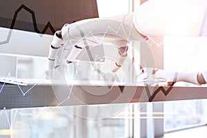 Close up of robot hands typing, graph