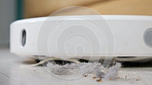 Close up of a robot vacuum cleaner driving on the floor