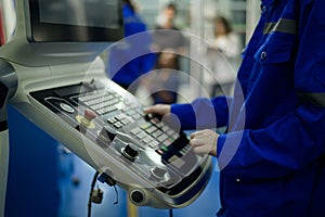 Close up of Robotics engineers Using Controller to Remotely Operate programming and Manipulating Robot Hand, Industrial Robotics