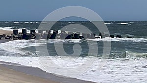 Close up of a rock jetty sticking out into the Atlantic Ocean on a very windy day