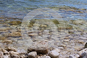 A close up of the rocky shoreline of Lake Michigan with water lapping over the rocks in Cave Point County Park, Wisconsin