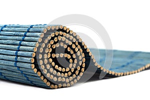 Close-up of a roll of blue bamboo food mat with soft focus