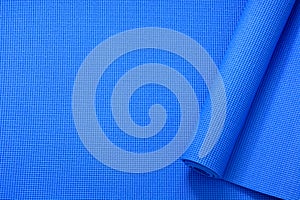 Close up roll blue color yoga mat texture background,top view, copy space, healthy lifestyle, sport and exercise concept