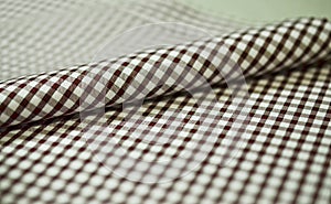 Close up roll brown scott pattern fabric of shirt