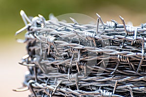 Close up on a roll of shiny new barbed wire