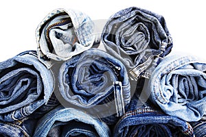 Close up rolled of blue jeans pants, dark blue denim trousers showing texture on white