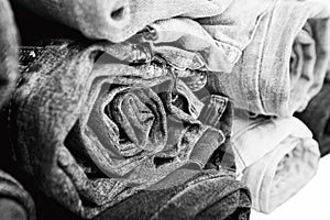 Close up rolled of blue jeans pants, dark blue denim trousers showing texture on white