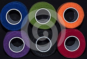 Close-up of rolls of colored fabric.