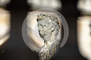 Close up of Roman statue on the terrace of the Roman Baths, Bath, Somerset, UK