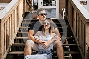 Close up of romantic couple in embrance look away on building background