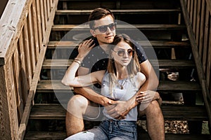 Close up of romantic couple in embrance look away on building background