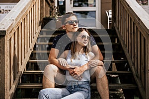 Close up of romantic couple in embrance look right away on building background