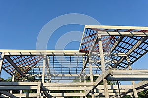 Close-up of roof construction home framing against blue sky