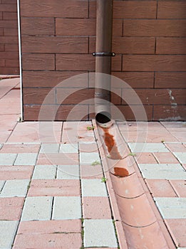 A close-up on the roof gutter downpipe with drainage system