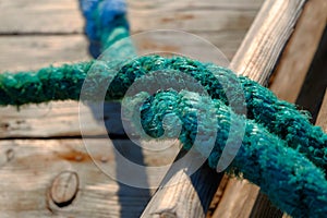 Close up on rope of green color of fishing boat