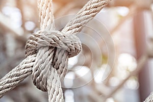 Close-up of rope knot line tied together with playground background.selective focus. photo