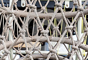Close-up of rope knot line tied together with playground background.