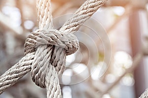 Close-up of rope knot line tied together with playground background.selective focus.