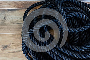 a close up of a rope on a wooden floor with wood boards