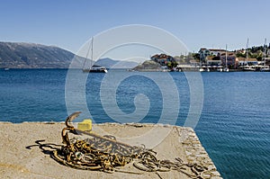 Close-up of ropes and anchor rusted on a pier in fiskardo bay