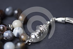 Close-up of rosary beads on a dark background
