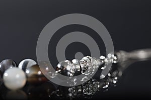 Close-up of rosary beads on a dark background