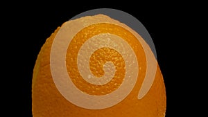 Close-up rotating ripe juicy oranges. Close-up of ripe orange peel.