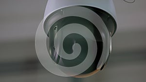 Close-up of rotating surveillance security video camera.