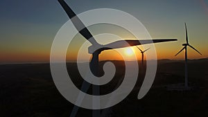 Close up of rotating windmill blades at sunset