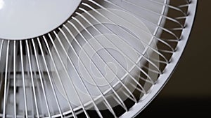 Close-up of the rotation of the fan blades. front electric fan grilles