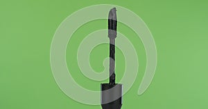 Close-up, rotation of mascara brush, on green screen.