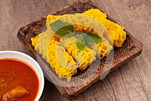 Roti Jala or Net Bread and curry sauce