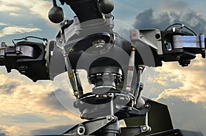 Close-up of the rotor blades of a helicopter in front of a dramatic sky