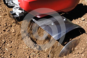 Close up rotovator working in a field