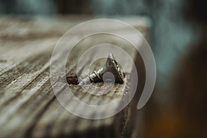 Close up rough wooden and rusty nail