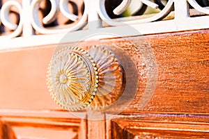 Close up on a round door handle with decorative elements, door d