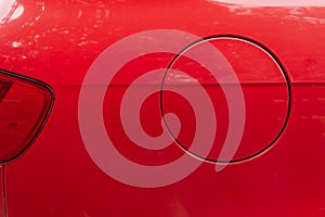 Close-up of the round fuel tank cap of a red car