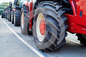 Close up row of brand new tractors outdoors