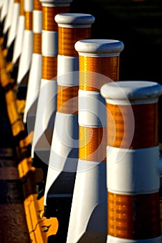 Close-up of a row of white traffic safety lane dividers
