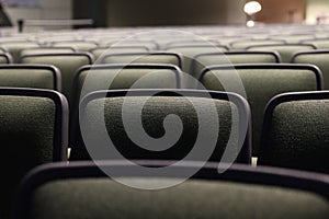 Close-up of rows of green fabric auditorium seats