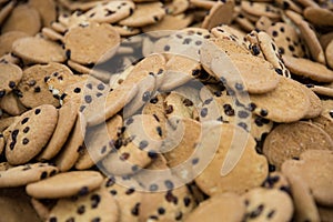 Close up of rows of oatmeal raisin cookies sitting on wax paper on table top