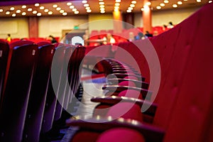 Close-up of rows of red seats in a theater photo