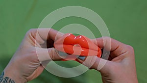 Close-up of rubber lips in the hands of a Dominatrix woman.