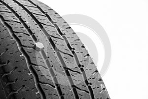 Close up of rubber tires leak, automobile tire drilled with a metal screw nail, isolated on white background