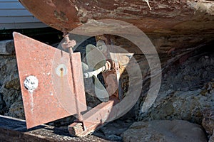 Close Up Of A Rudder And A Rusty Propeller Of A Dry Wooden Old B