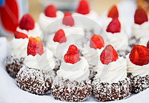 Close up of rum cakes with custard and strawberry