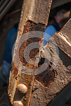 Close-up of rust on bars of the iron structure of the Eiffel Tower in Paris.