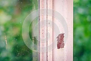 Close up of rust on an old white iron window