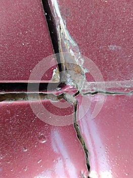 Close-up of a rusted steel plate that has been corroded until it is damaged.